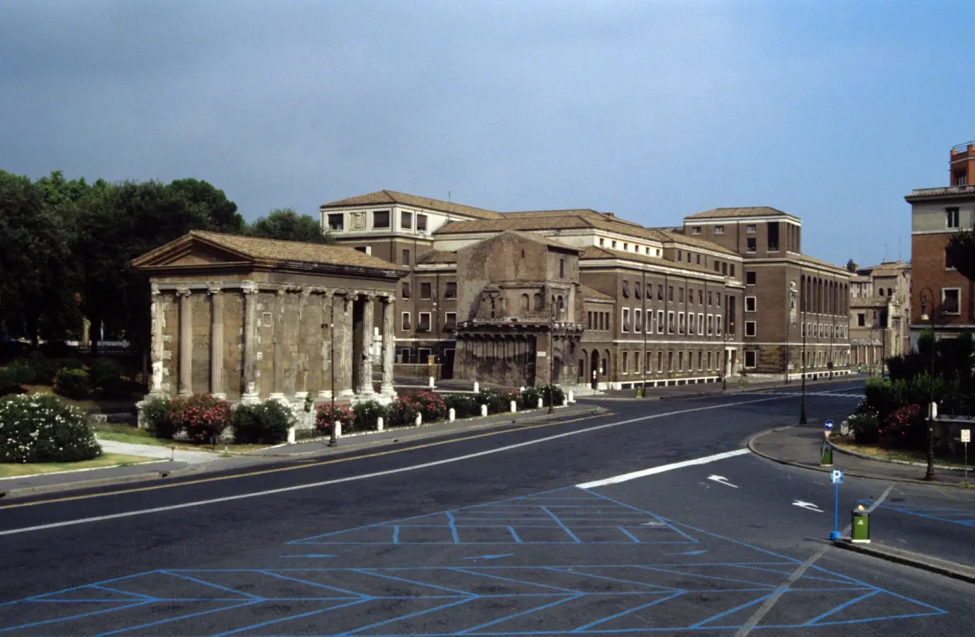The Roman Temple of Portunus in front of the large brick anagrafe building on Via Luigi Petroselli in Rome