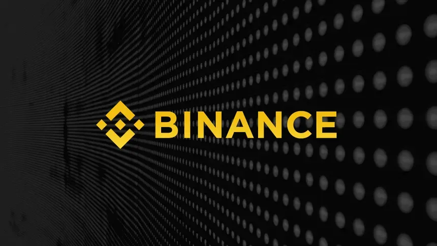 The yellow Binance logo on a dark background of dots