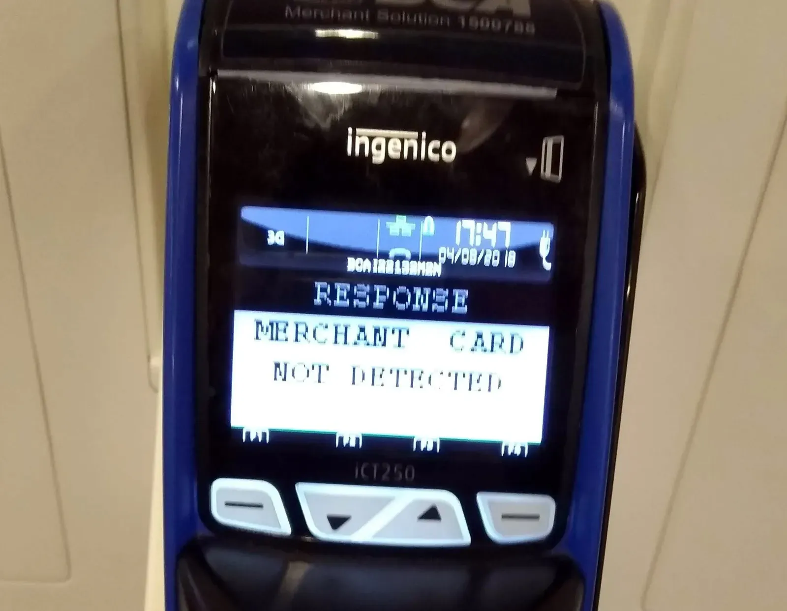 Close-up of an Ingenico card terminal whose screen reads "Merchant card not detected"