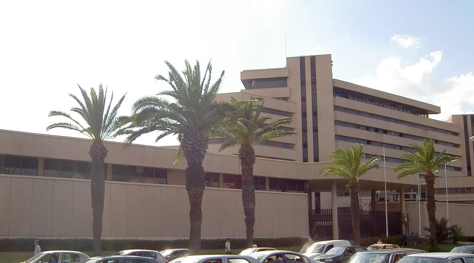 The headquarters of the Central Bank of Tunisia in Tunis, a large modern building behind palm trees