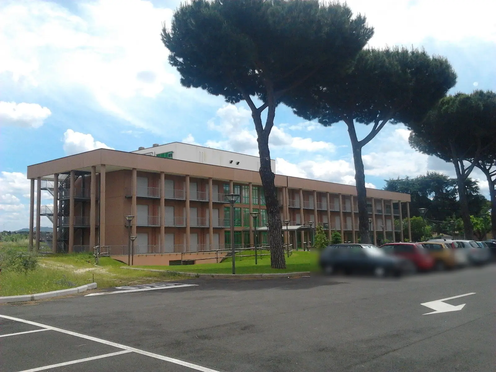 A student residence and canteen building under umbrella pines at Tor Vergata, Rome