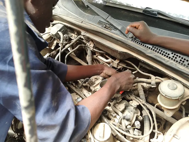A mechanic's hands repairing a car engine