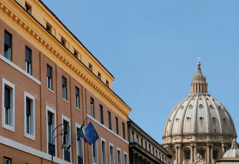 A LUMSA building on Via della Traspontina with the dome of St Peter's behind it