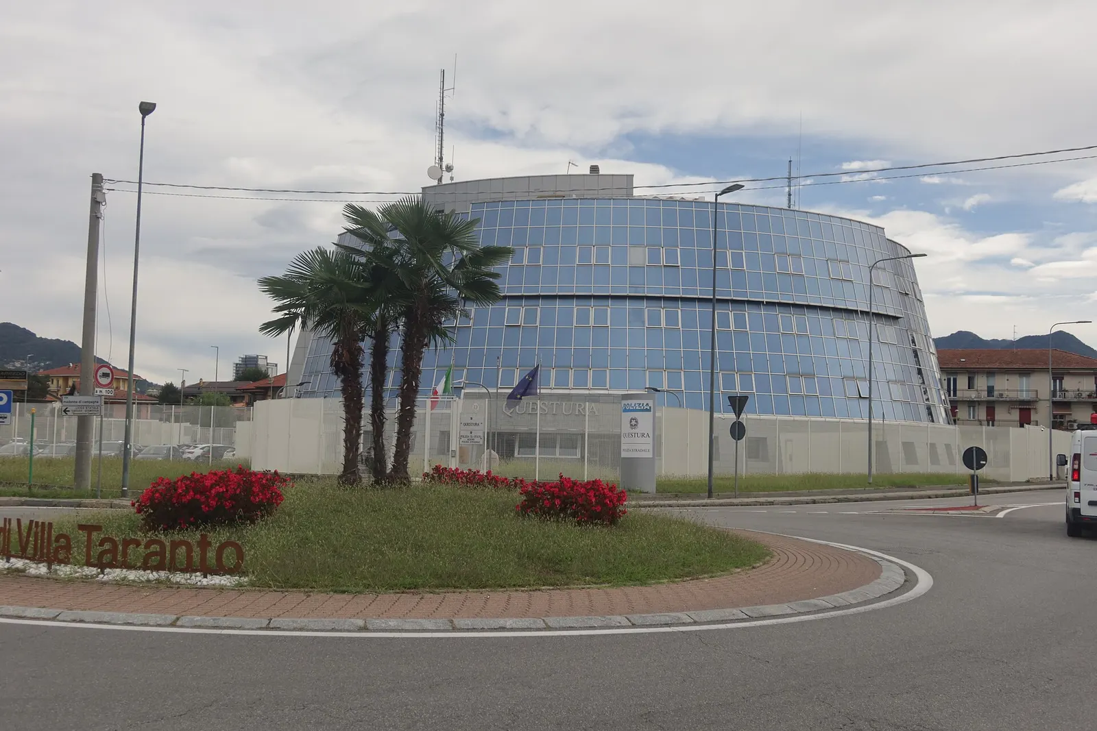 The Questura building in Verbania, Italy, with the Italian and European flags at the entrance